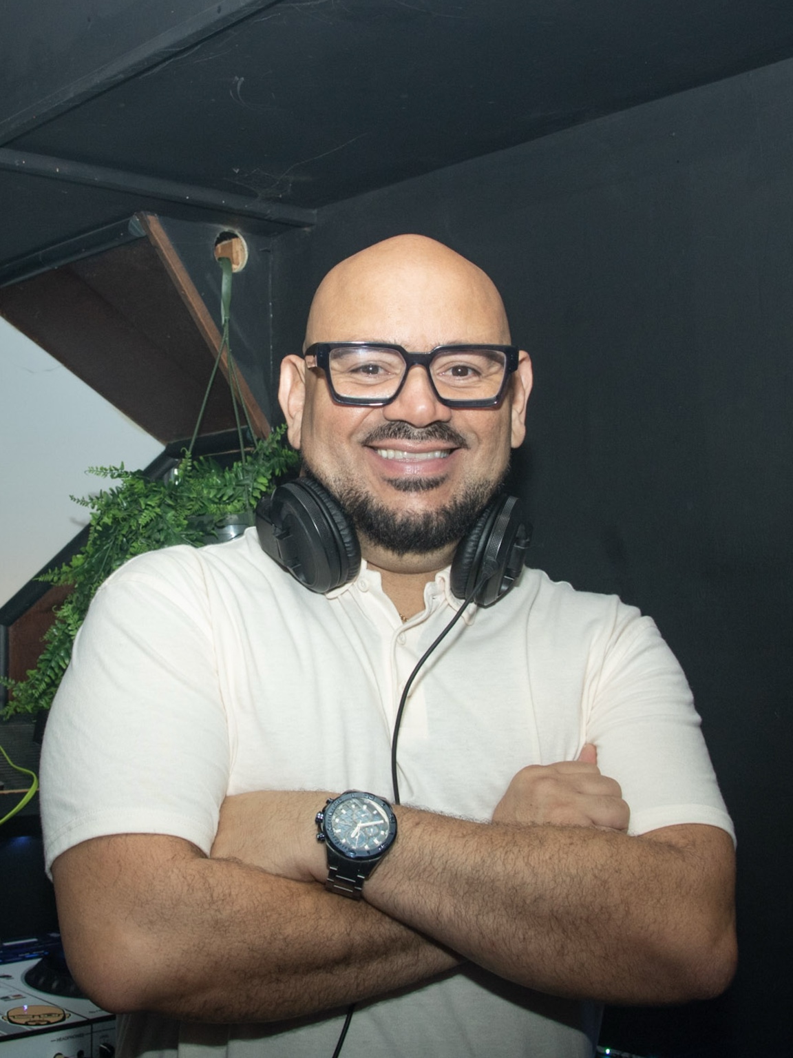 Smiling DJ wearing headphones at an event